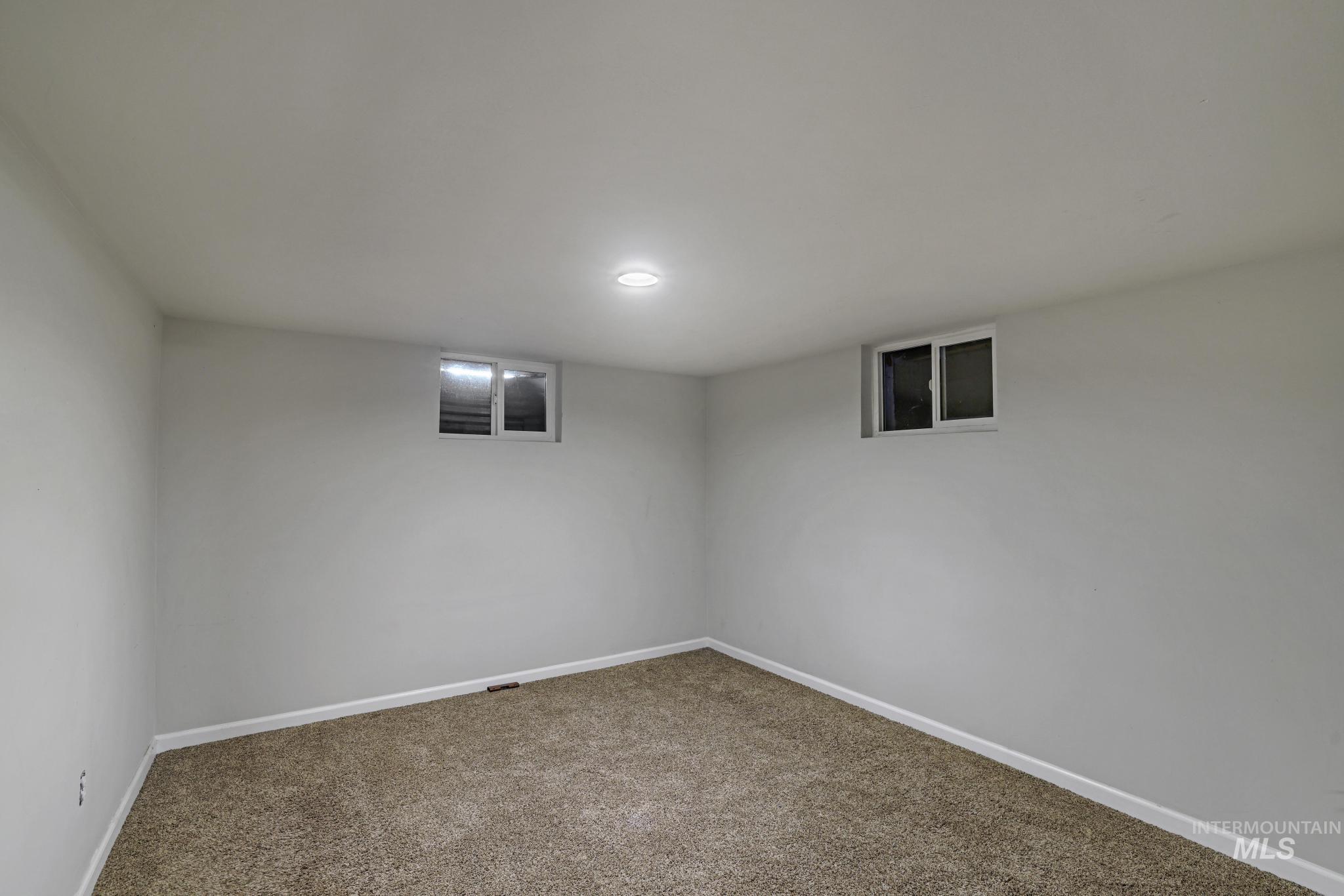 Finished basement with baseboards and carpet floors