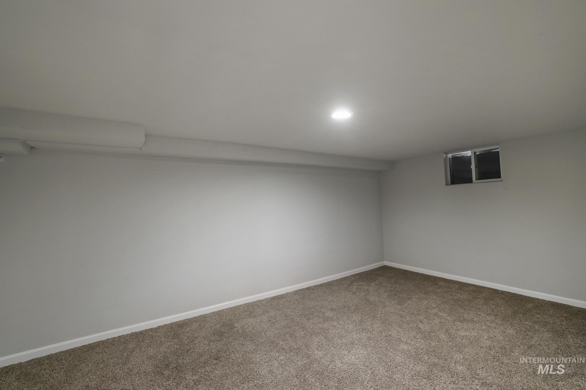 Finished below grade area with baseboards and carpet floors