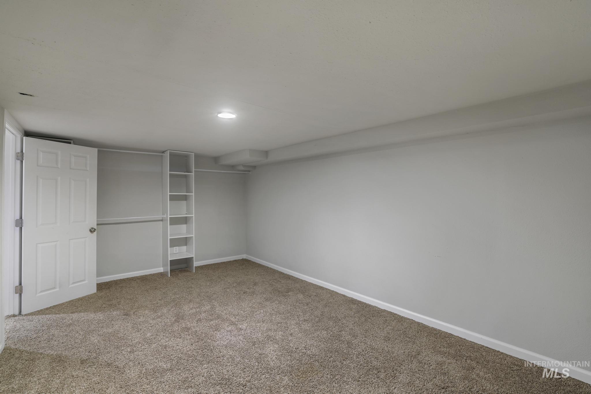 Finished basement featuring baseboards and light colored carpet