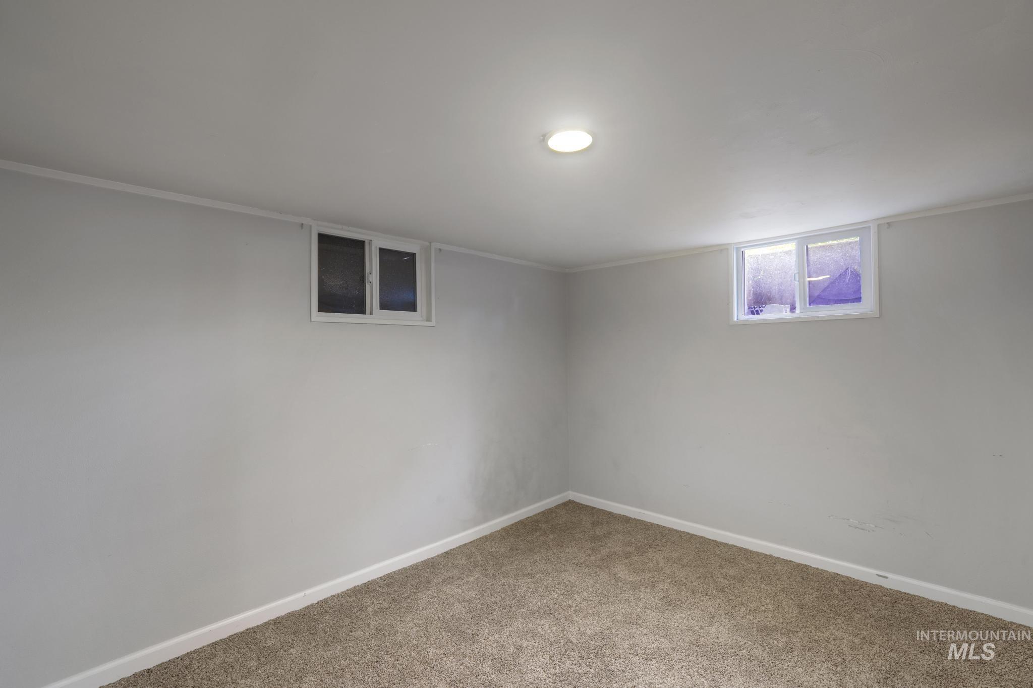Below grade area featuring baseboards and carpet flooring