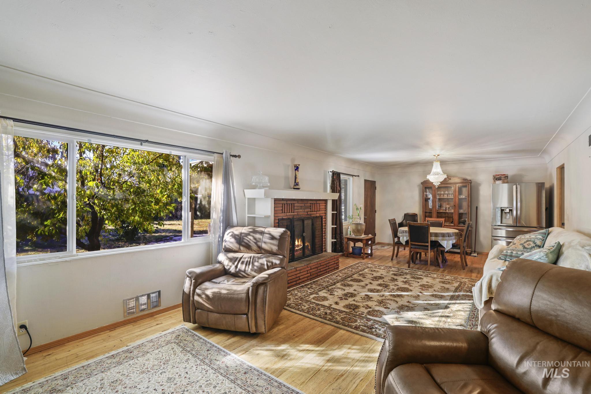 Living room with light wood-style flooring and a fireplace