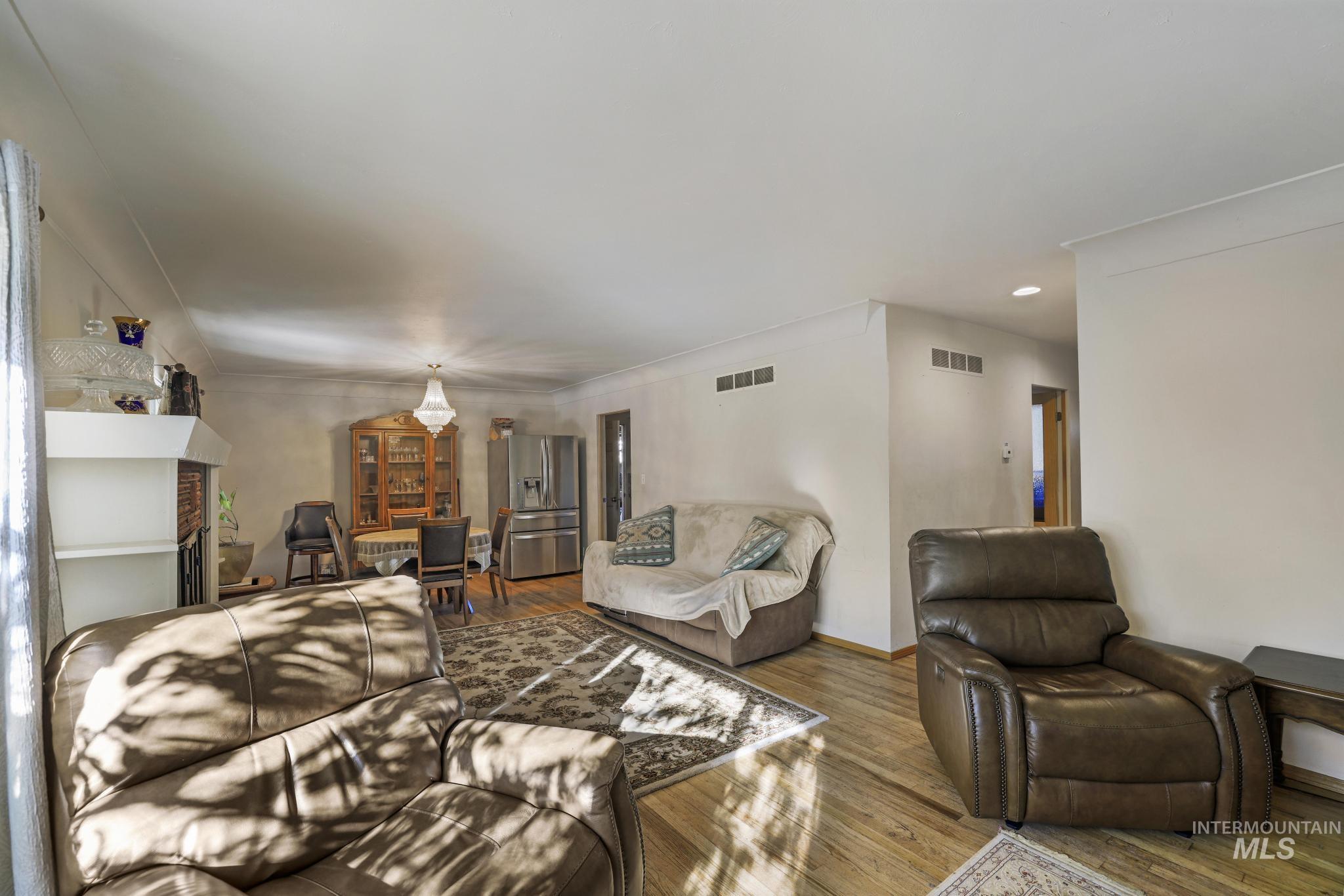 Living area with wood finished floors and baseboards