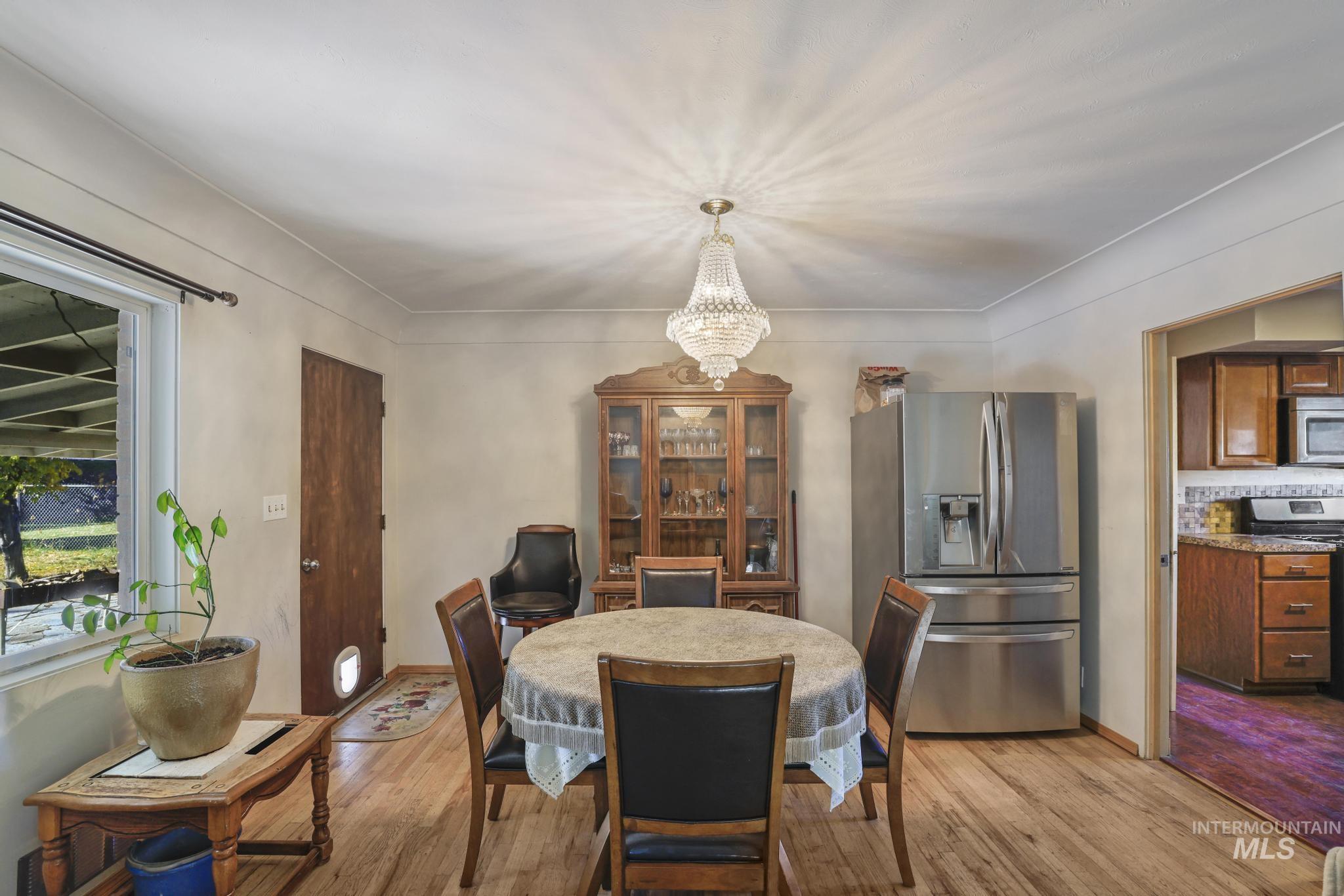 Dining space featuring a chandelier and light wood finished floors