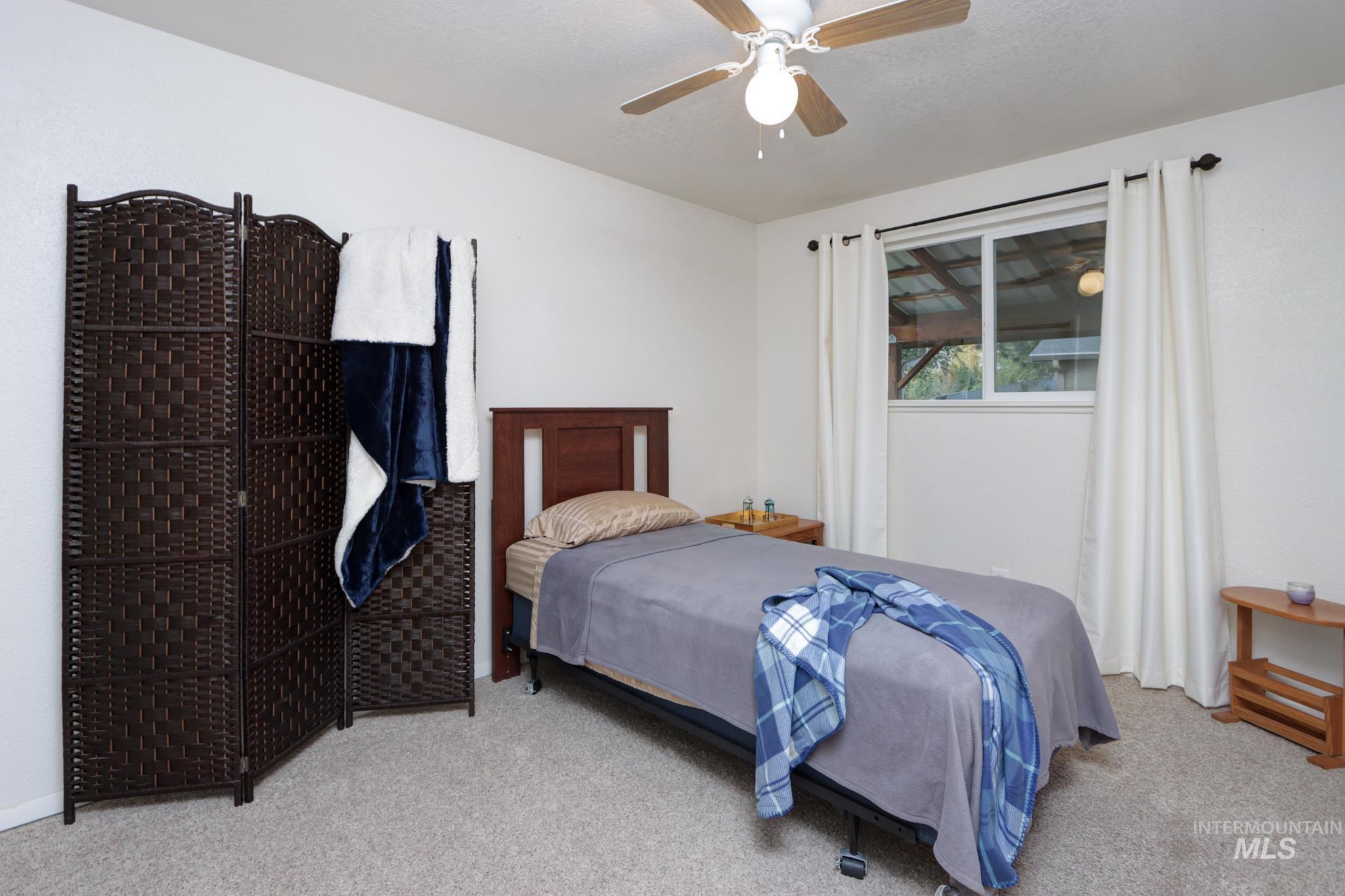 Bedroom with carpet flooring and ceiling fan