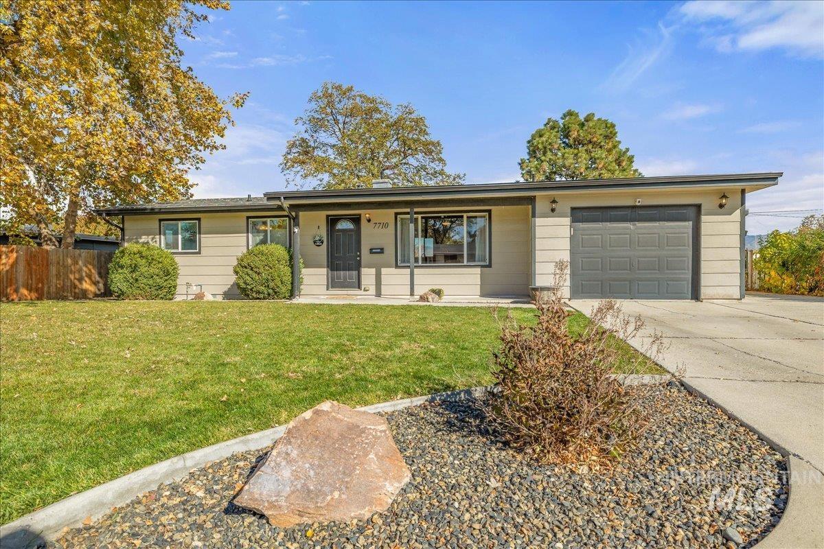 Ranch-style home with driveway, a garage, and a porch
