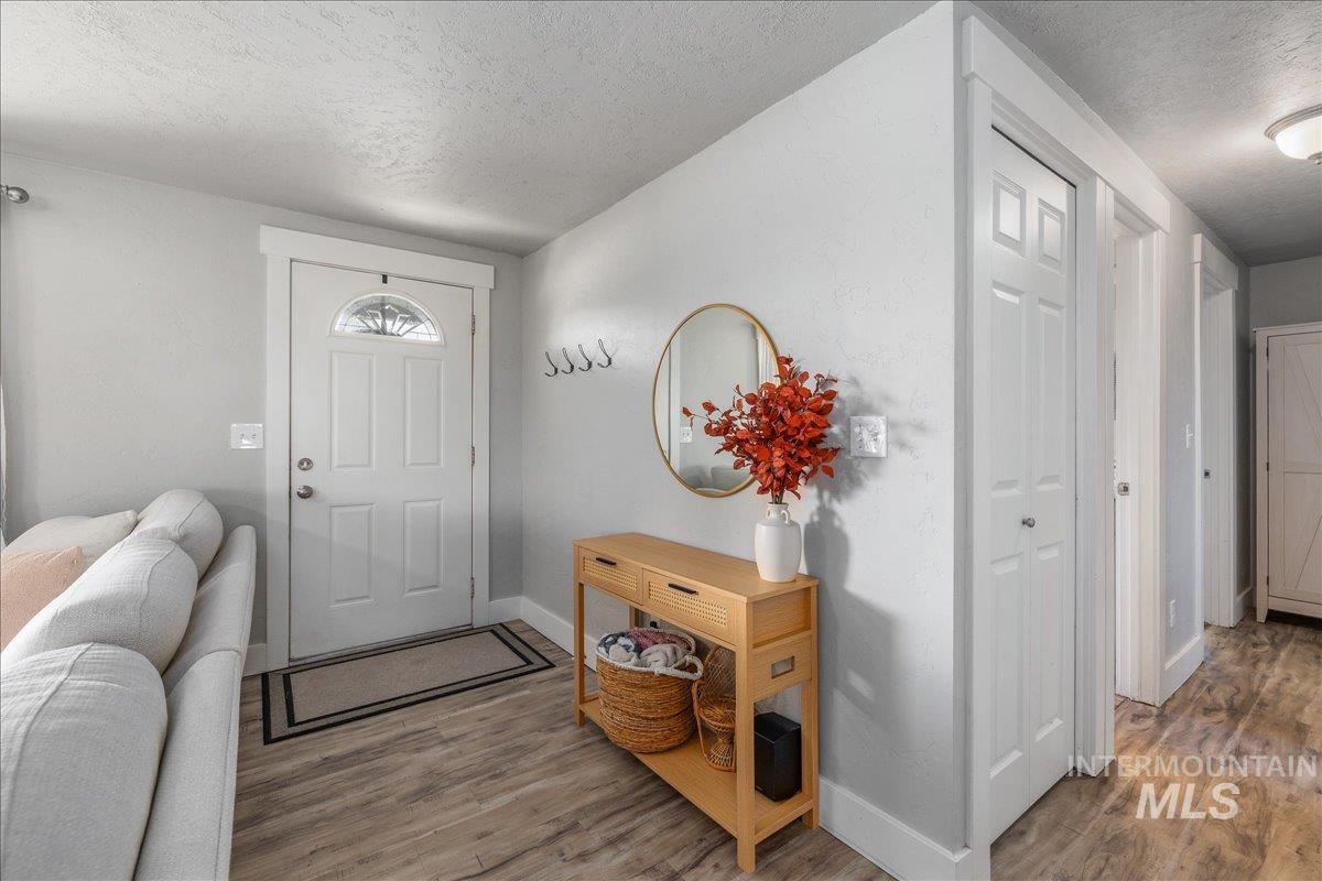 Foyer featuring a textured ceiling and wood finished floors