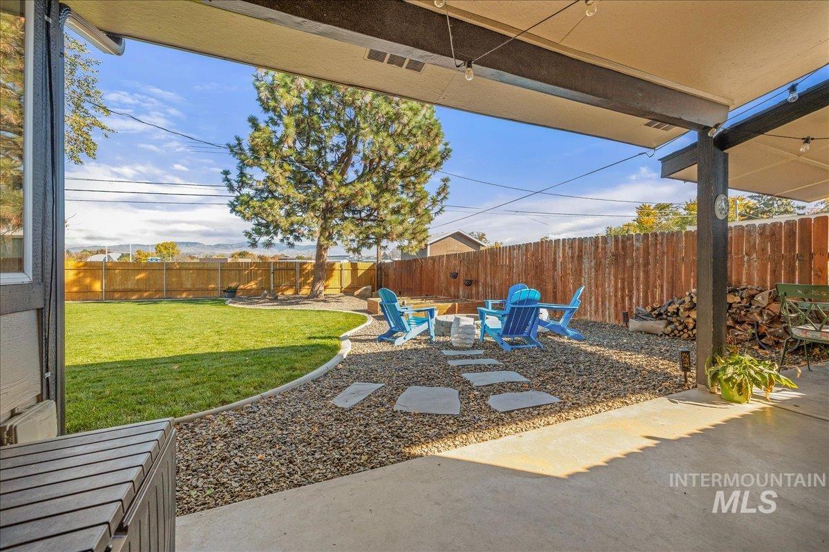 Fenced backyard featuring a patio and an outdoor fire pit