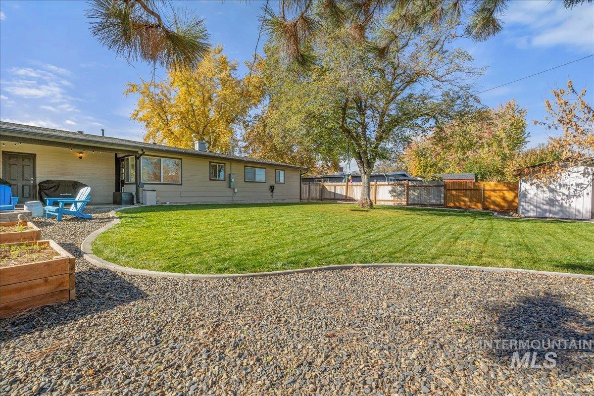 Back of property with a patio, a fenced backyard, and a vegetable garden