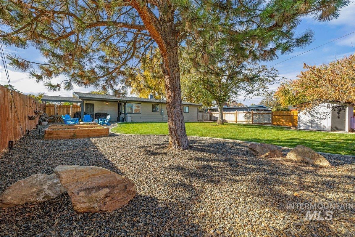 Rear view of property featuring a patio area and a fenced backyard