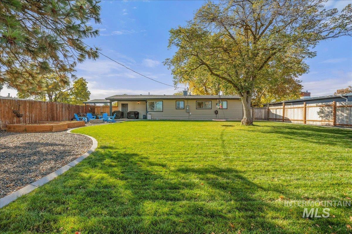 Rear view of property featuring a fenced backyard and a patio