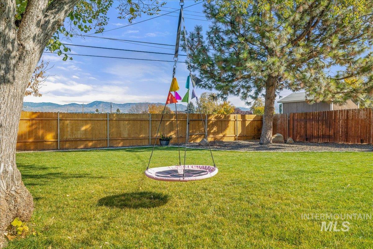 Fenced backyard featuring a mountain view