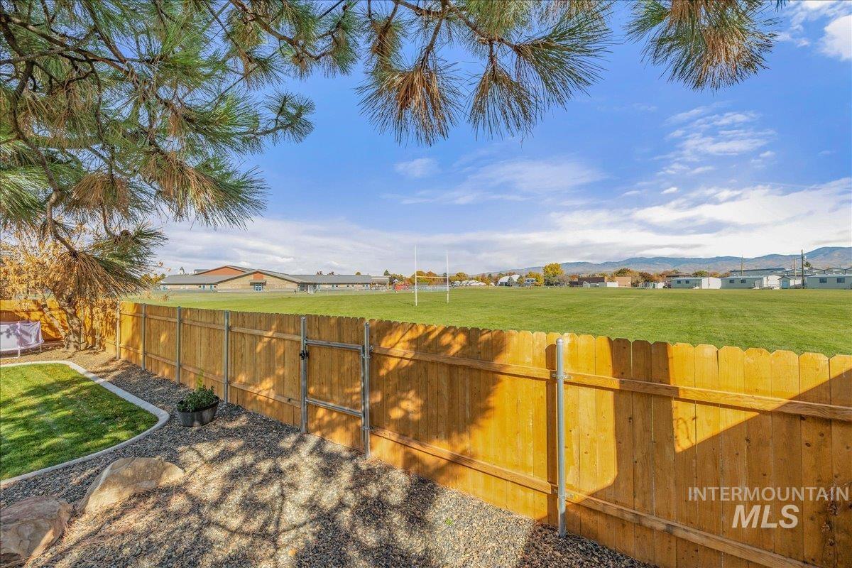 Fenced backyard with a mountain view