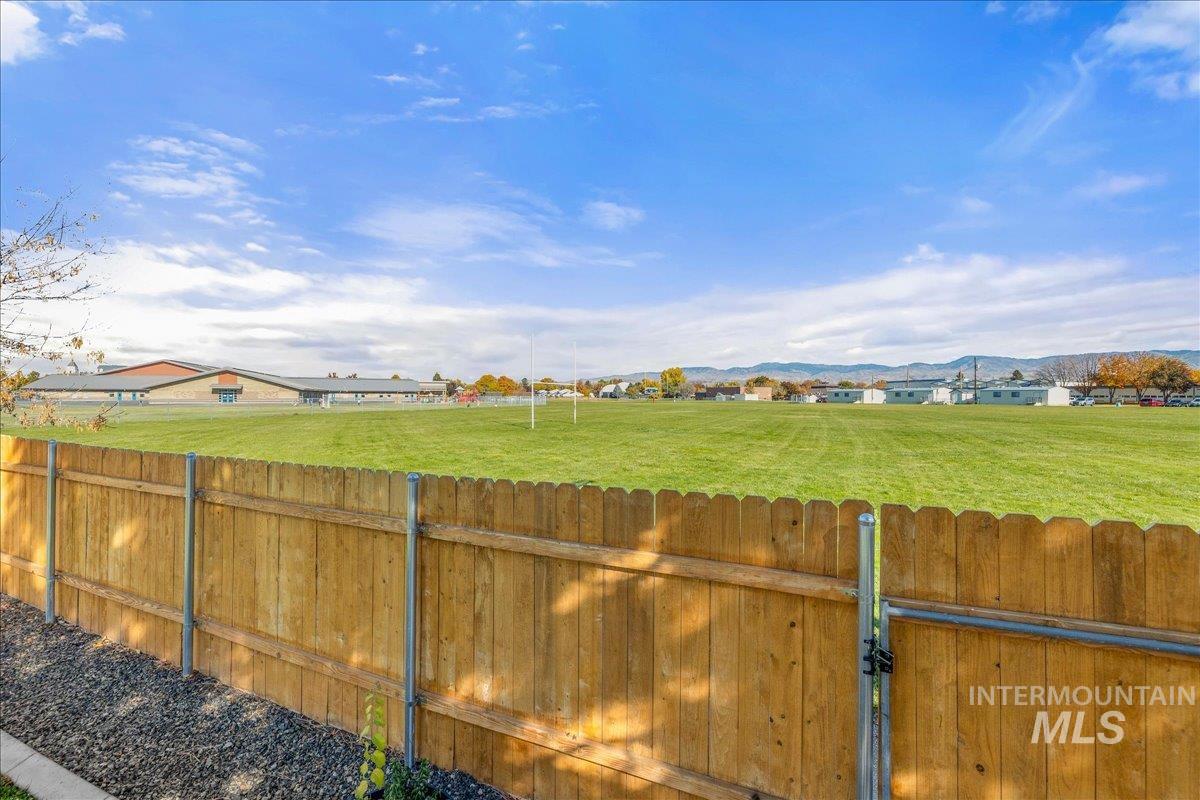 View of yard featuring a mountain view and a gate
