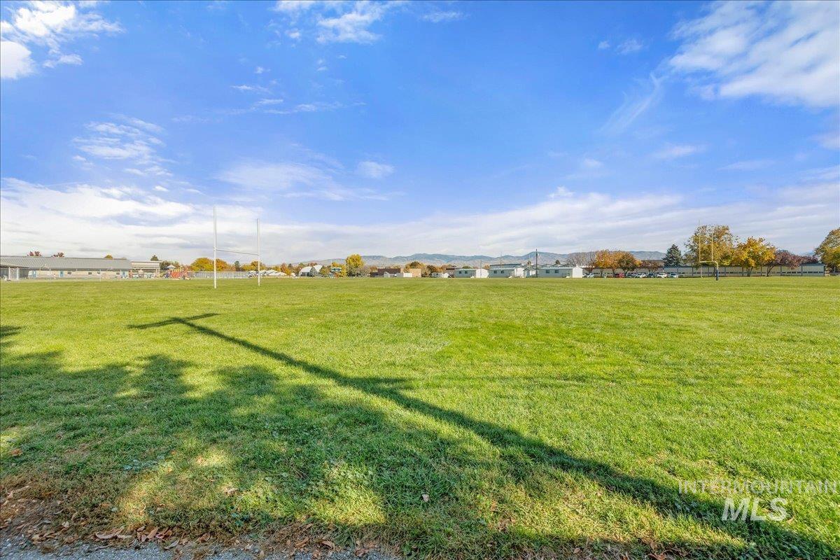 View of green lawn featuring a mountain view