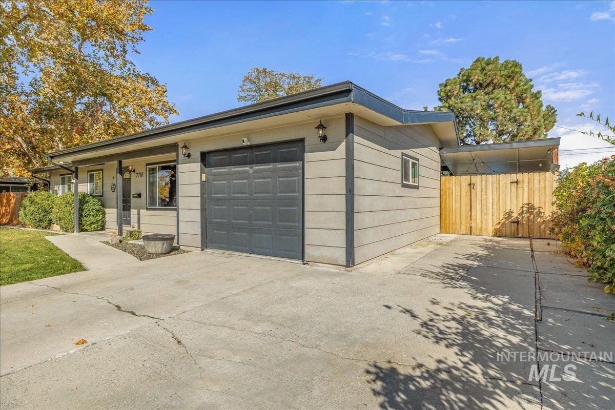 View of side of property with concrete driveway and an attached garage