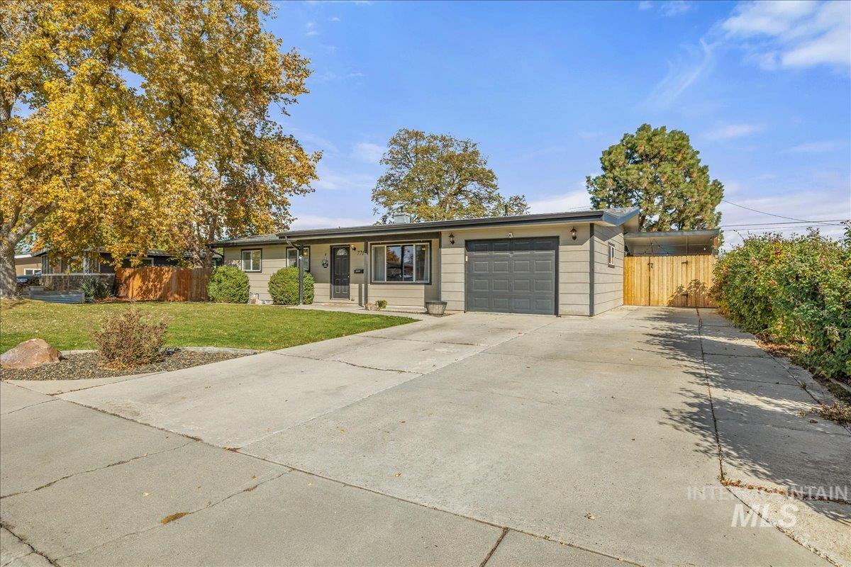 Ranch-style house with concrete driveway and an attached garage