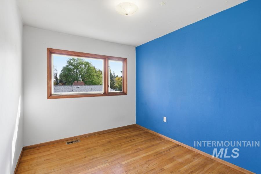 Spare room with wood finished floors and baseboards