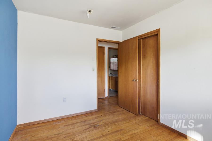 Empty room featuring baseboards and light wood-style flooring