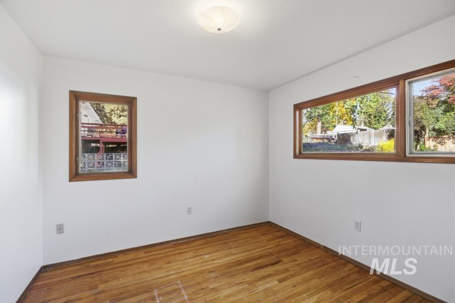 Unfurnished room featuring light wood-style floors and baseboards