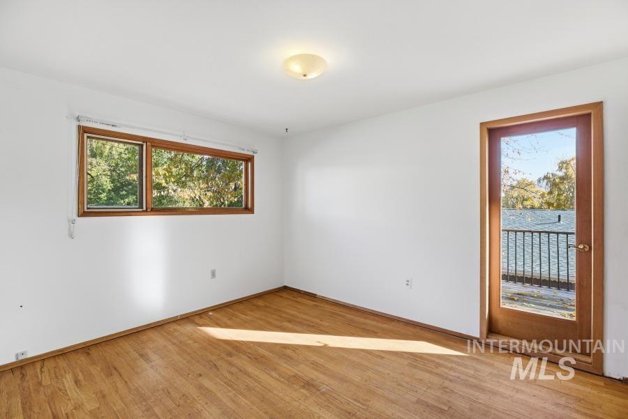 Spare room featuring light wood-style flooring and baseboards