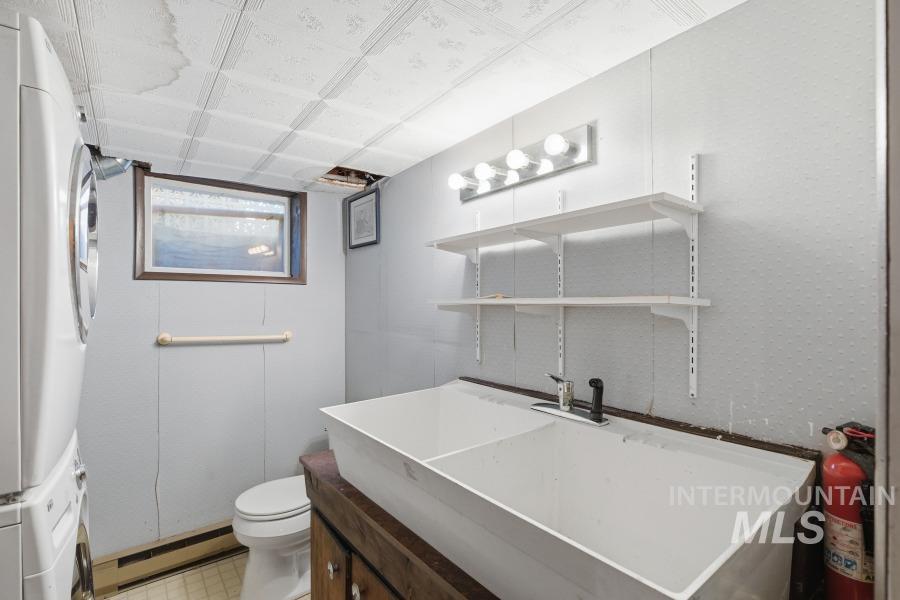 Half bathroom with vanity and baseboard heating