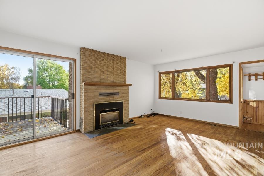 Unfurnished living room featuring a fireplace and wood finished floors