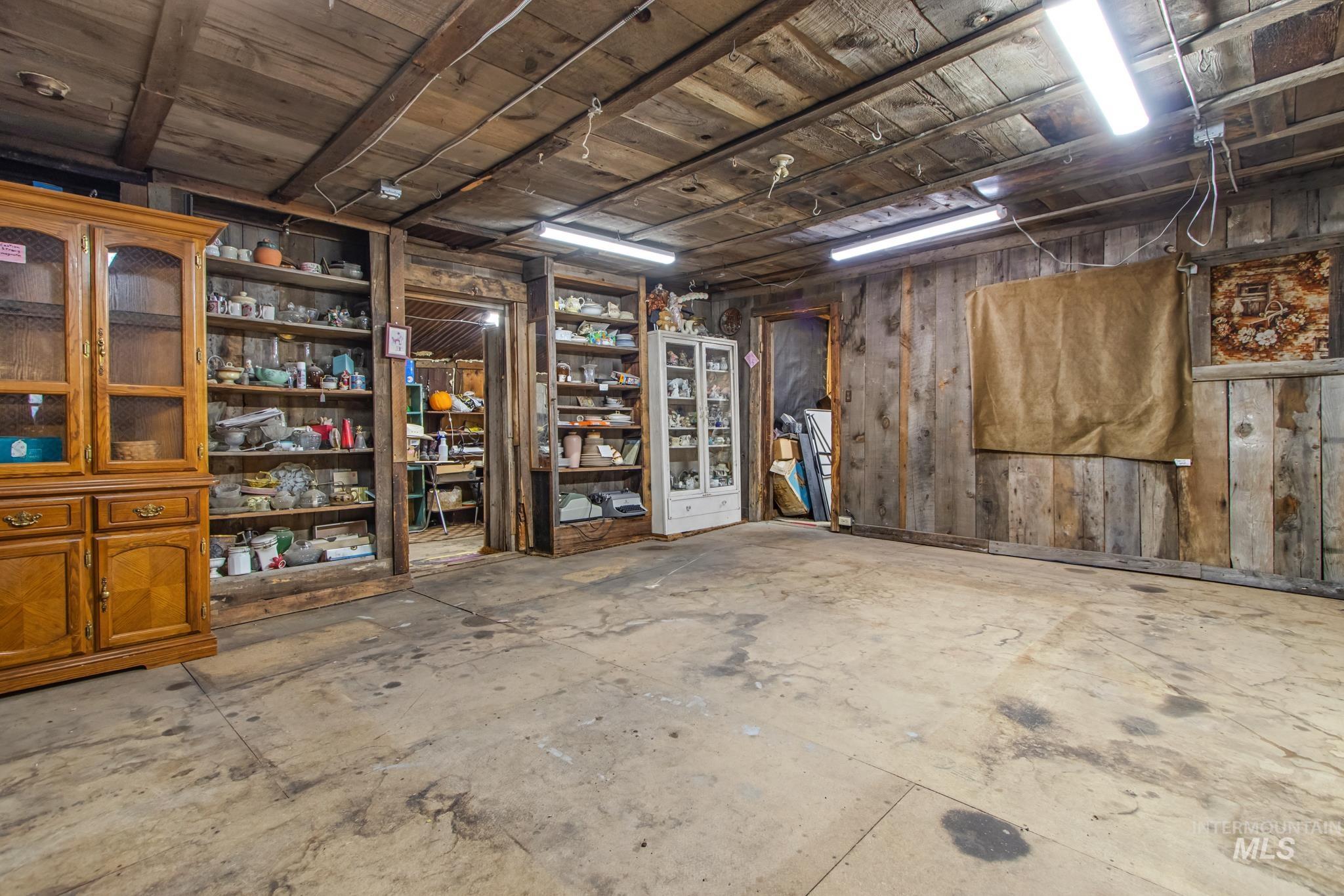 Basement featuring wood walls and wood ceiling