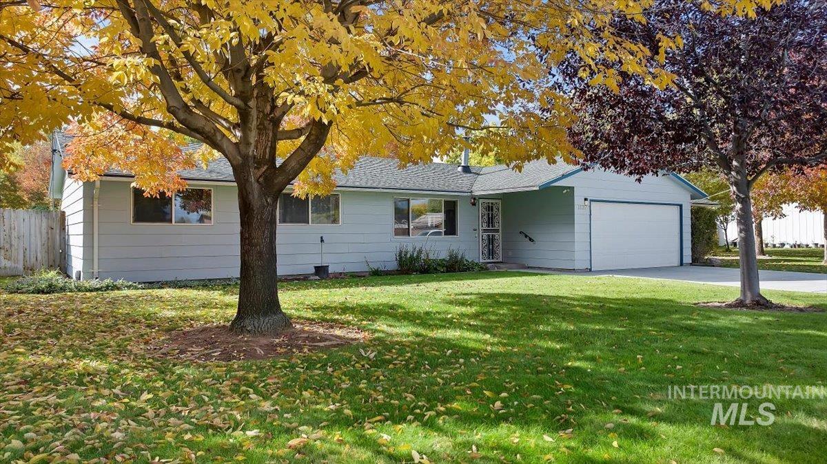 Ranch-style house featuring an attached garage and concrete driveway