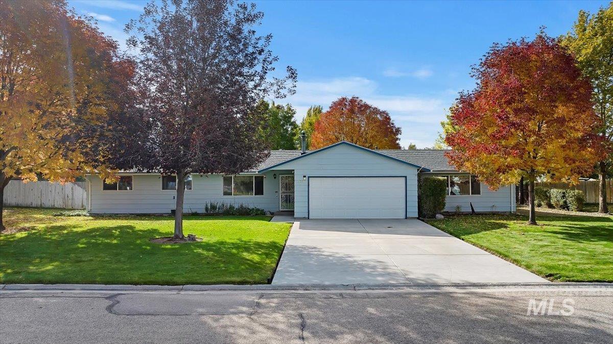 Ranch-style house featuring driveway and an attached garage