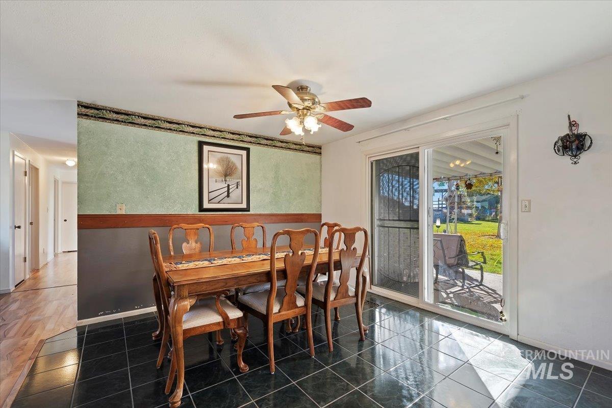 Dining space with ceiling fan and baseboards