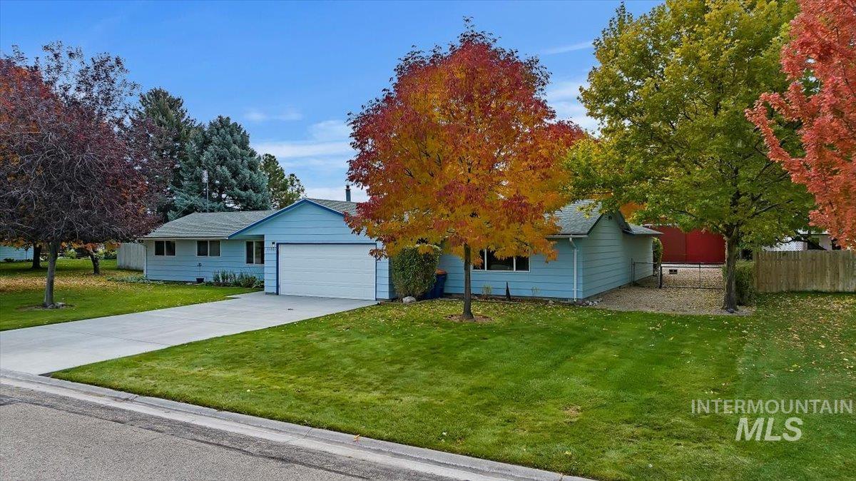 View of front of home with concrete driveway and a garage