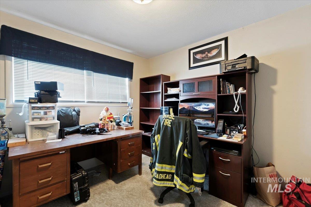 Home office featuring light colored carpet