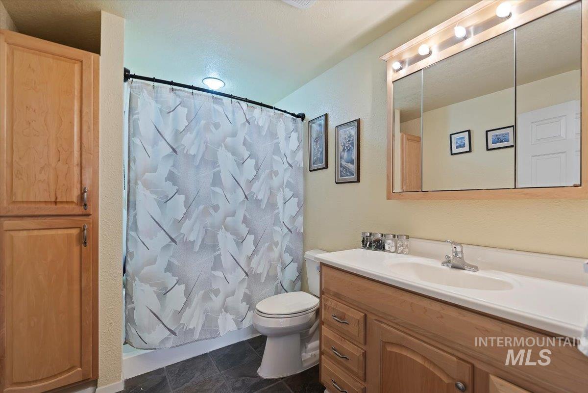 Full bathroom featuring a shower with shower curtain and vanity