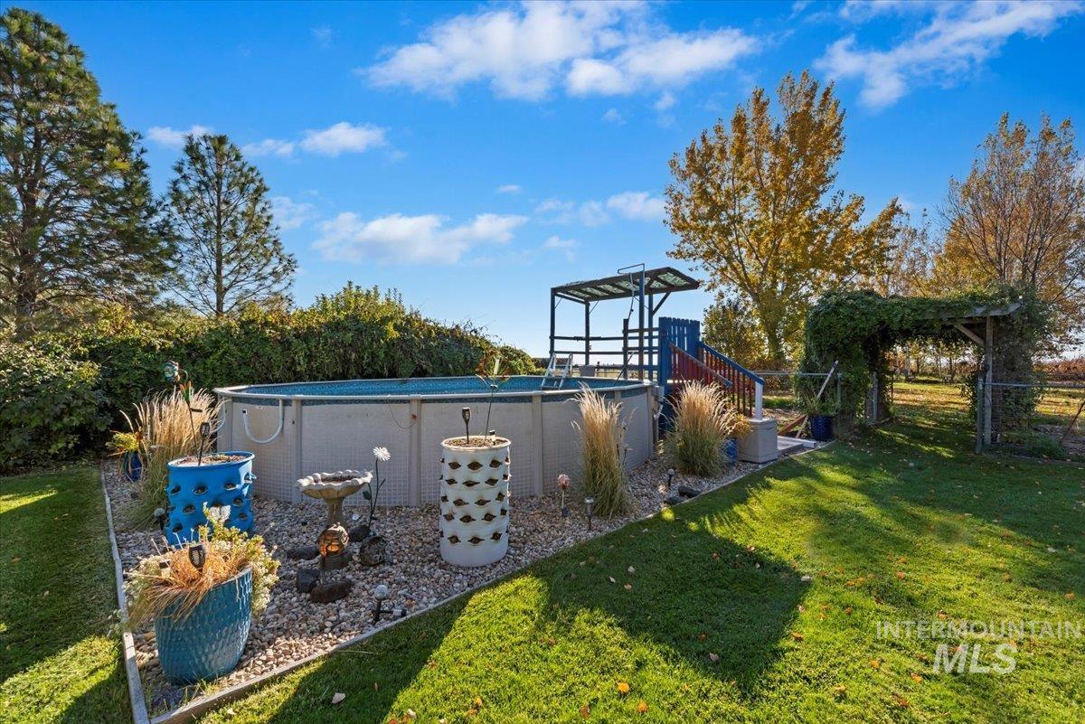 View of green lawn with an outdoor pool