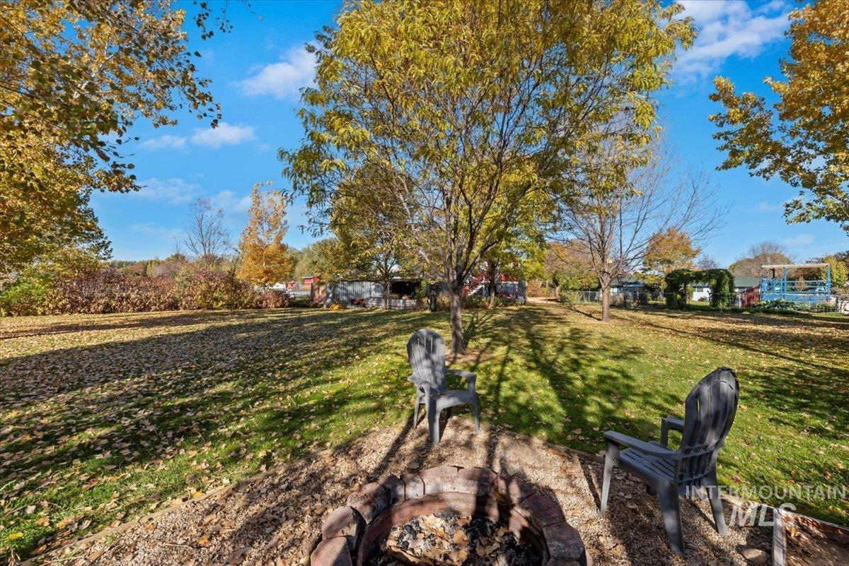 View of green lawn with an outdoor fire pit