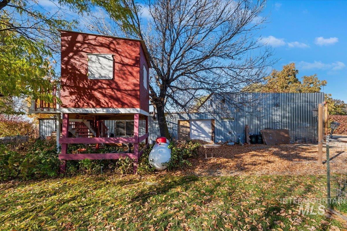 Rear view of property with a yard
