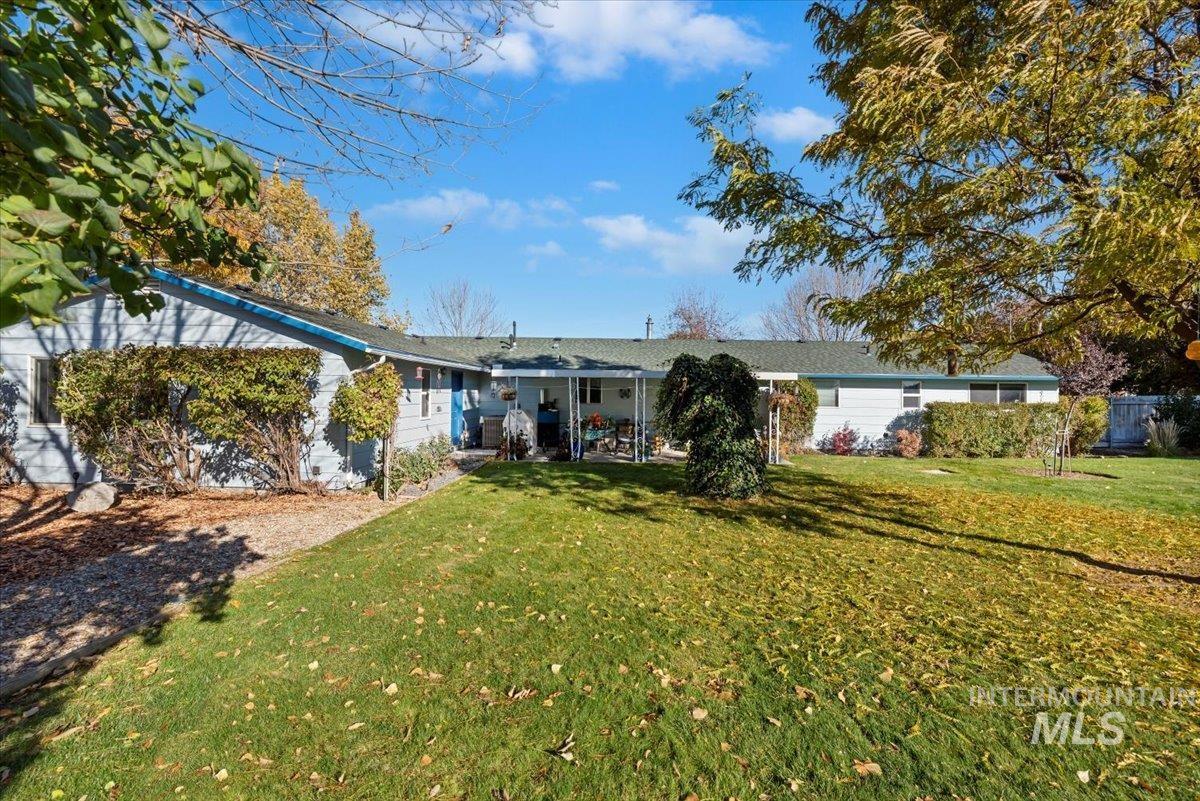 View of front of home with a patio and a front yard