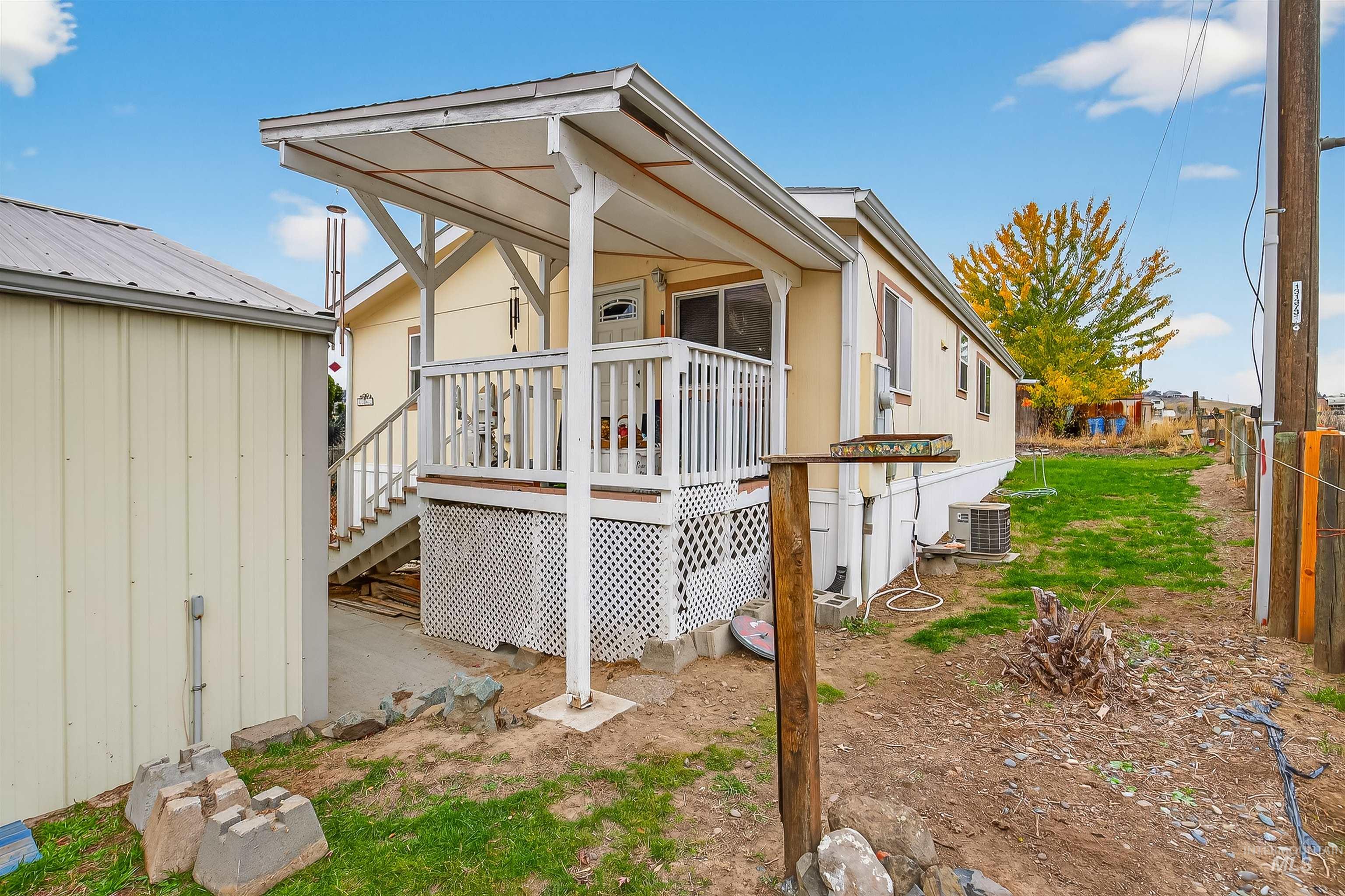 Rear view of property featuring a wooden deck and stairway