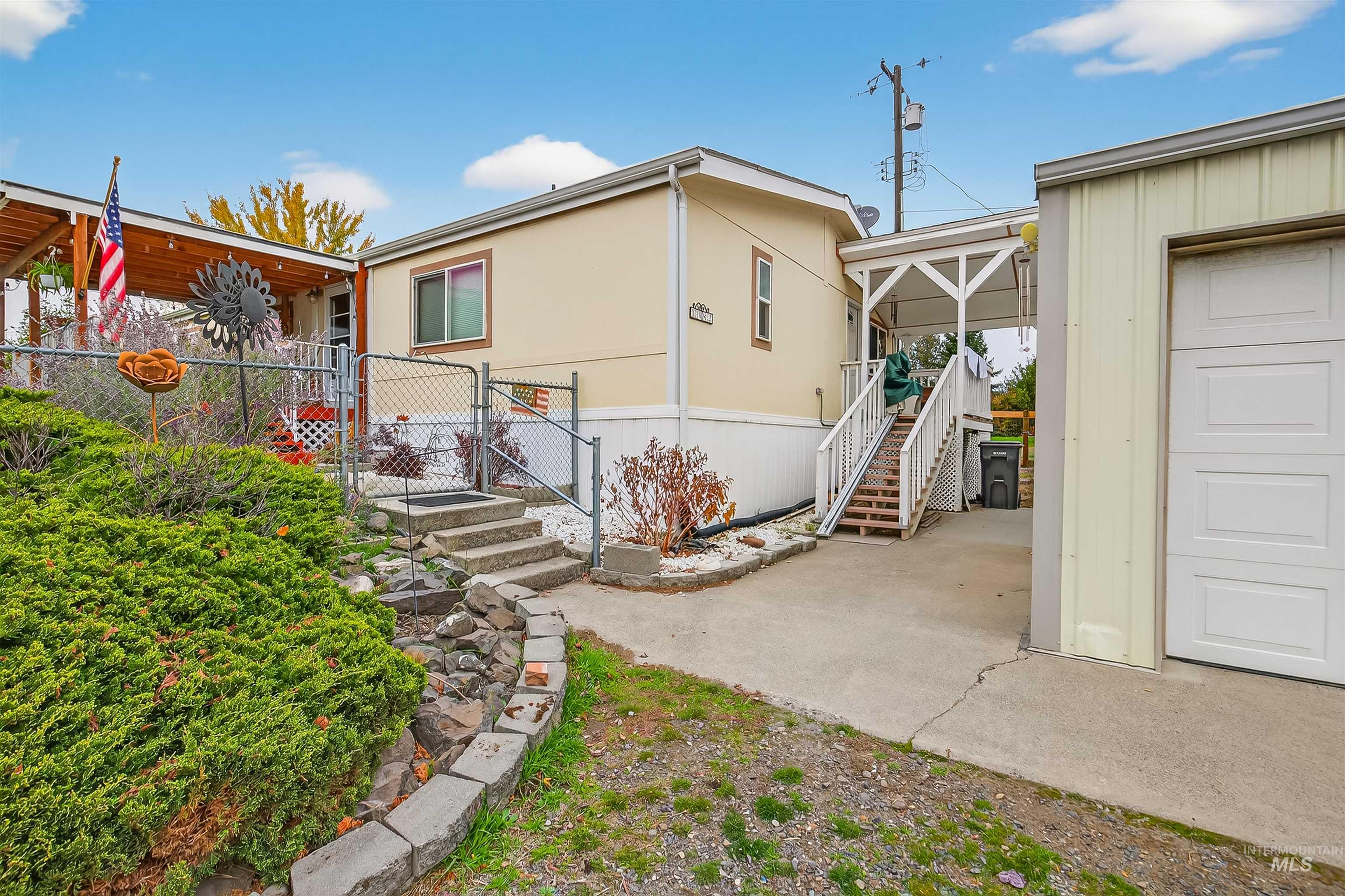 View of property exterior with stairs and a gate