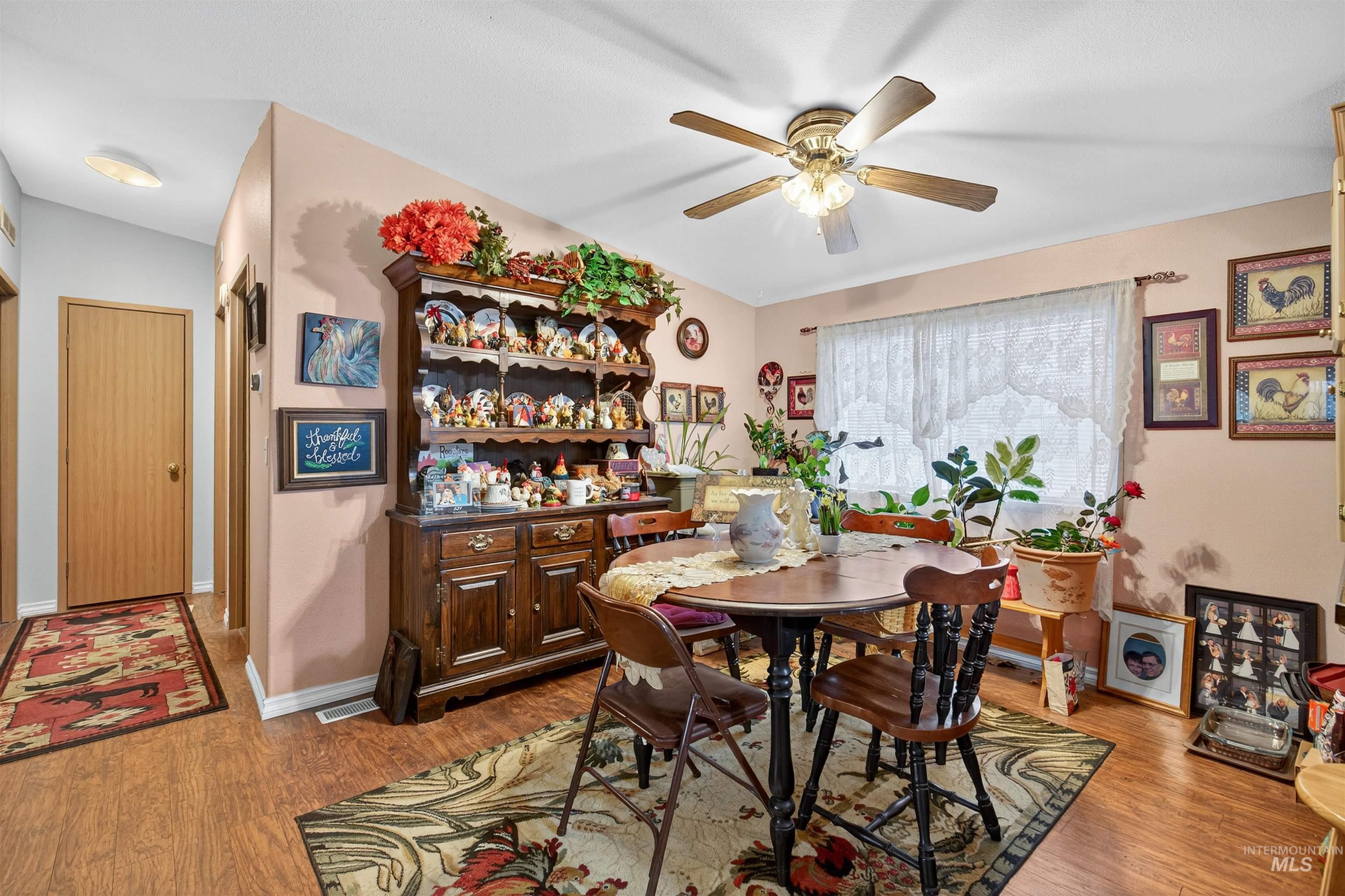 Dining room with light wood-style flooring and ceiling fan