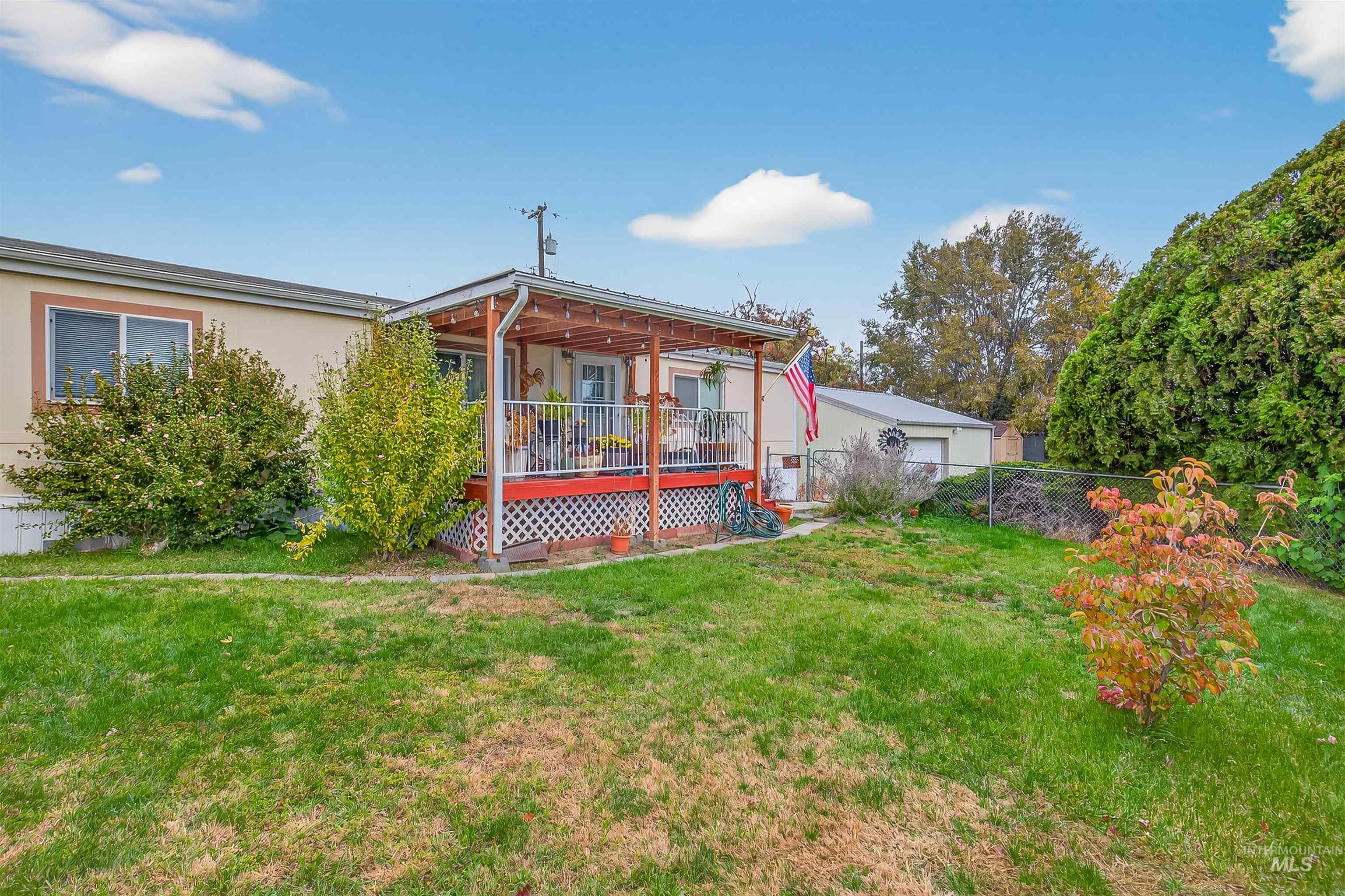 Rear view of property with a deck and stucco siding