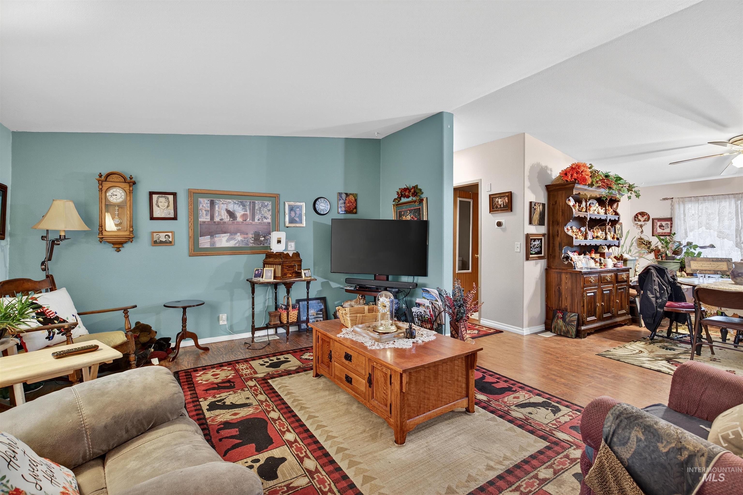 Living room with wood finished floors and a ceiling fan