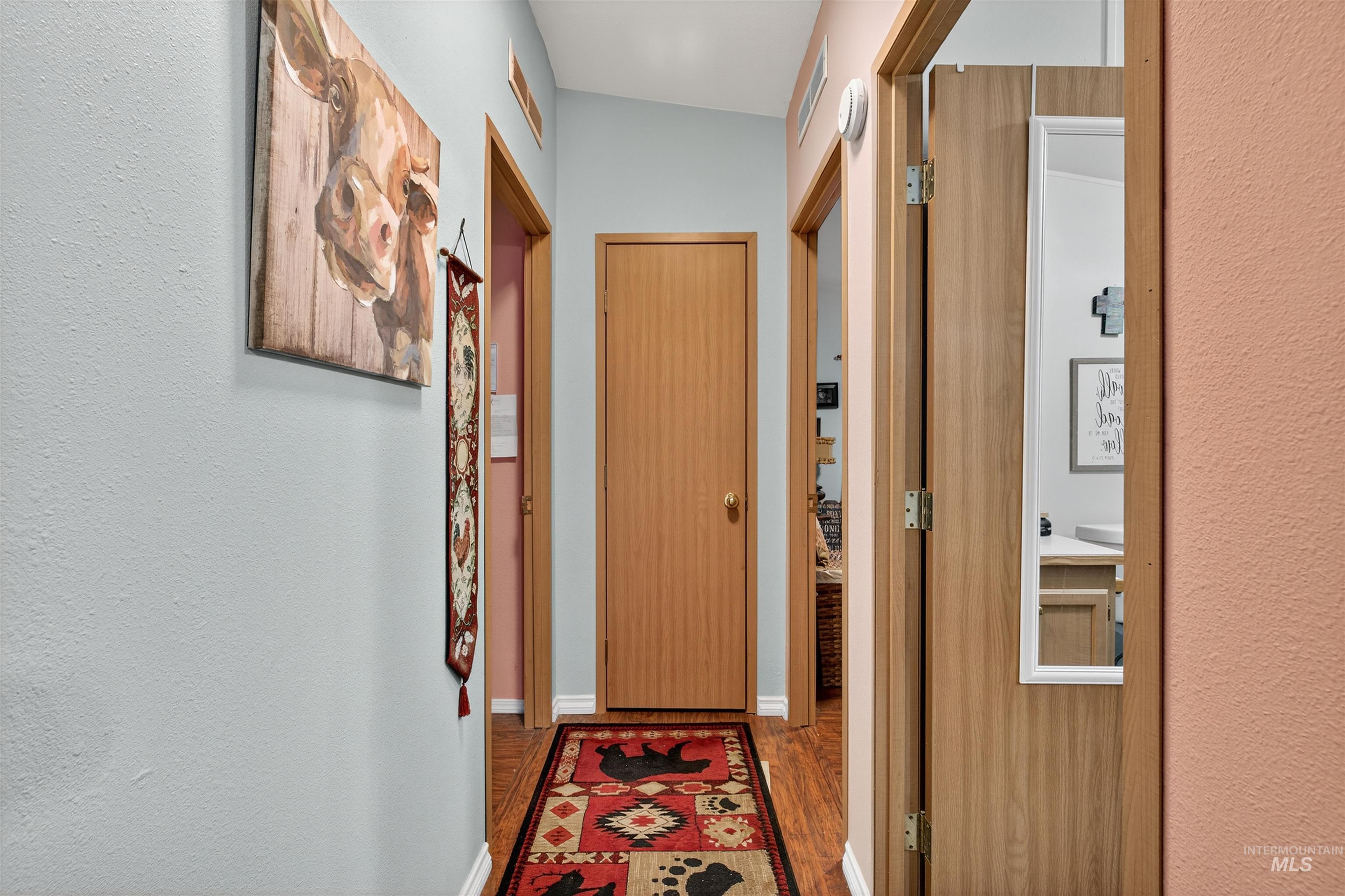 Entryway featuring wood finished floors and a textured wall