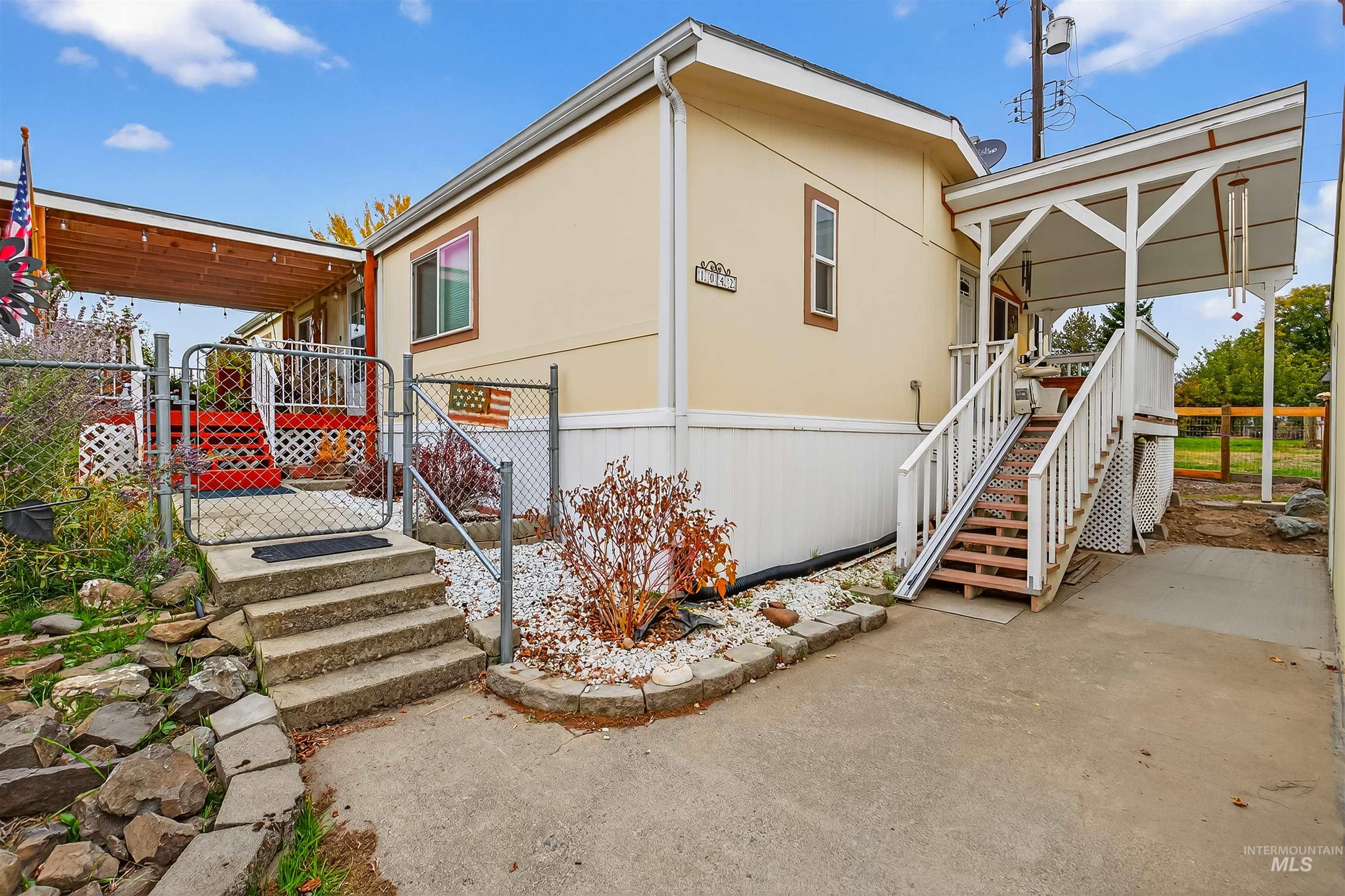 View of home's exterior with stairway and a gate