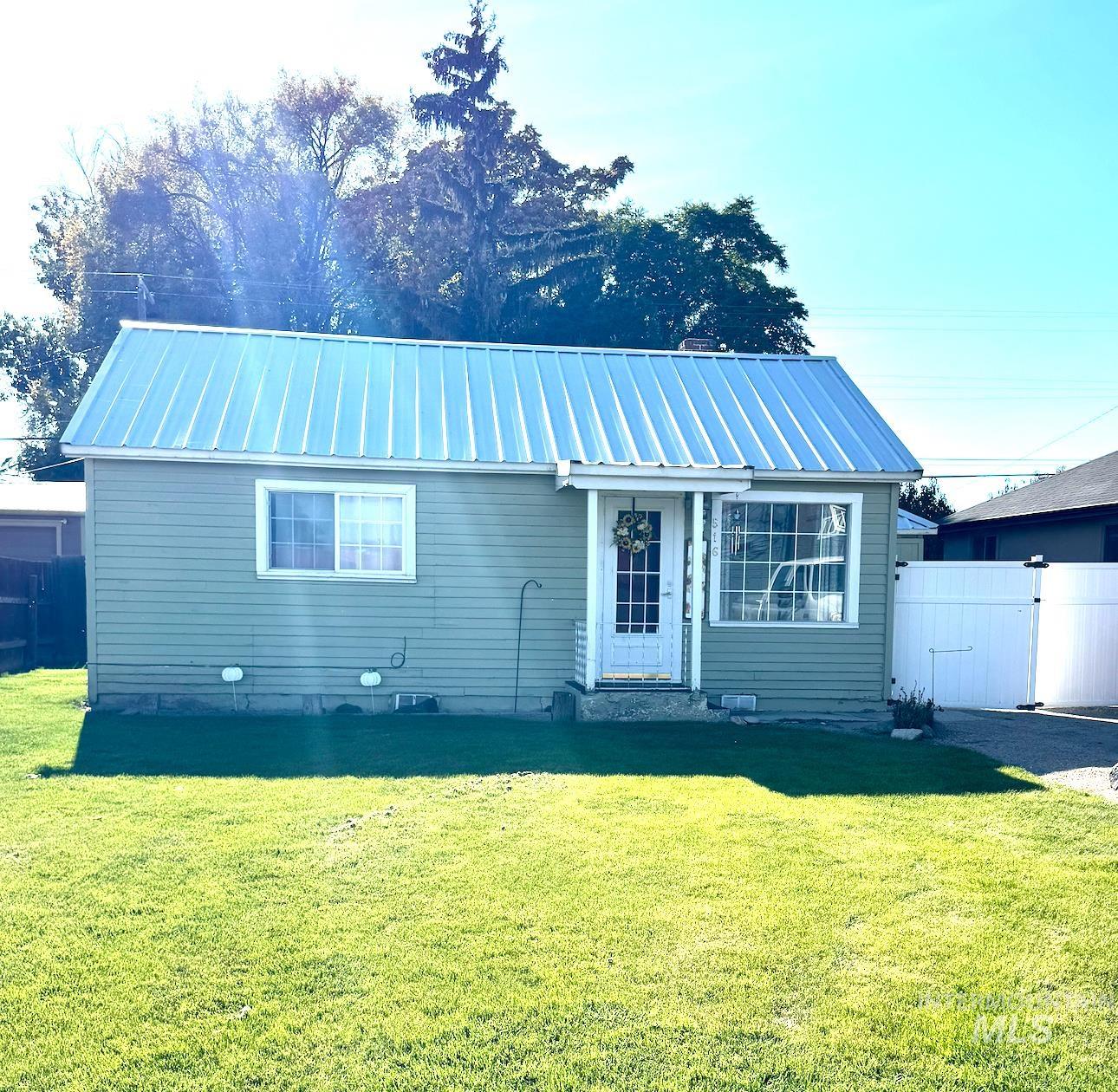 View of front of home featuring a metal roof and a standing seam roof