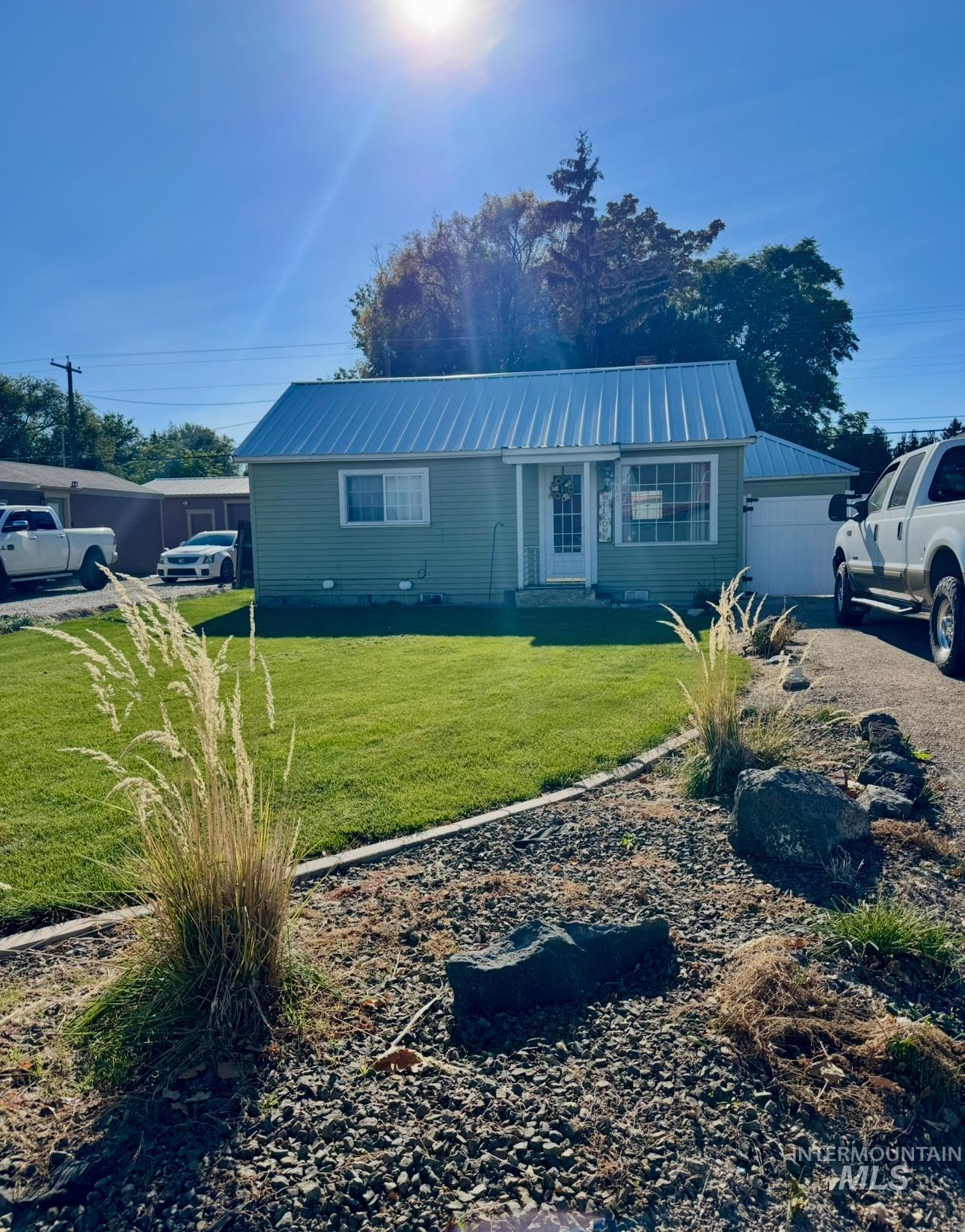 Ranch-style home with a front yard and a metal roof