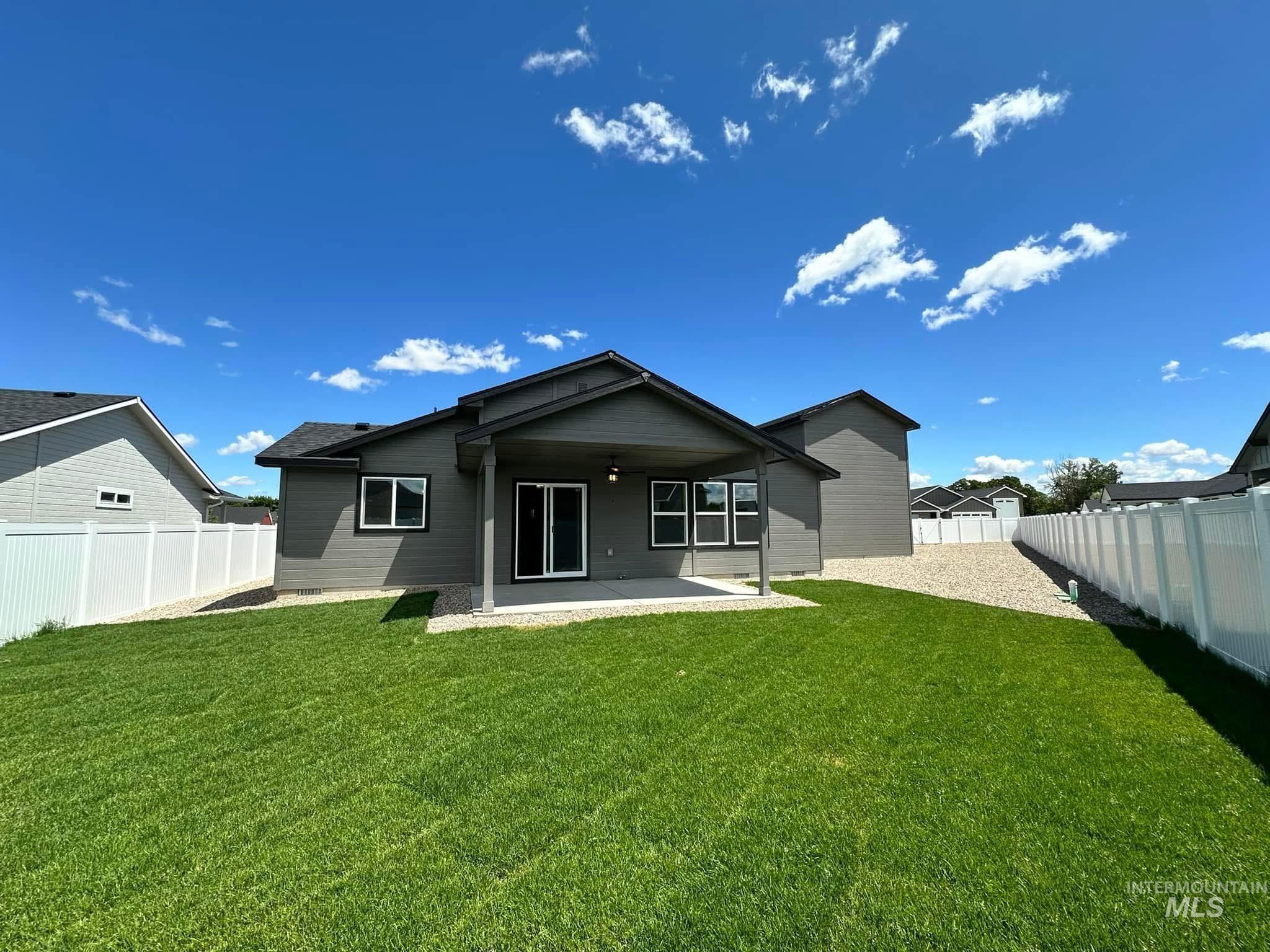 Back of house with ceiling fan, a patio, and a fenced backyard