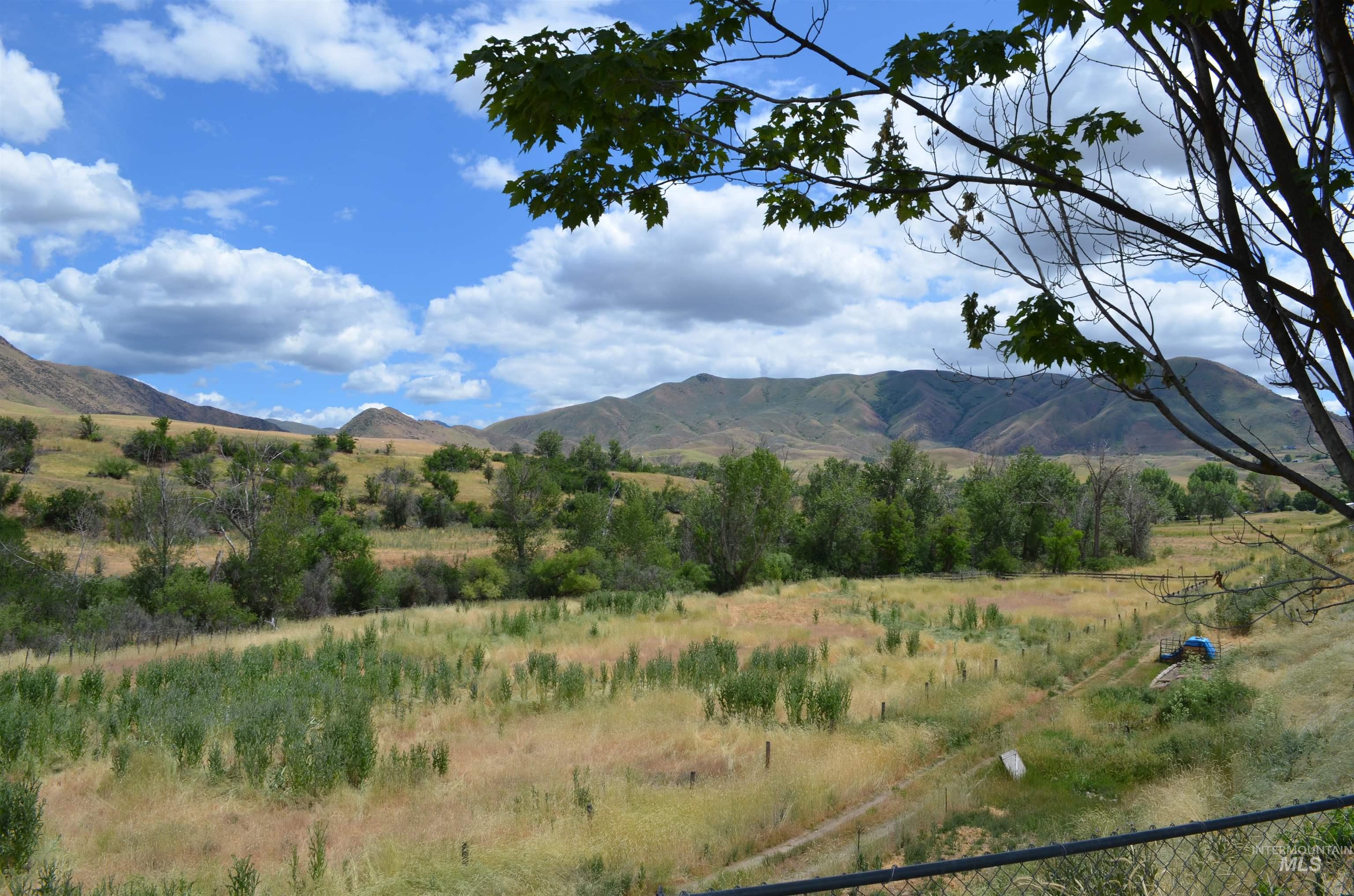 View of mountain backdrop with rural landscape
