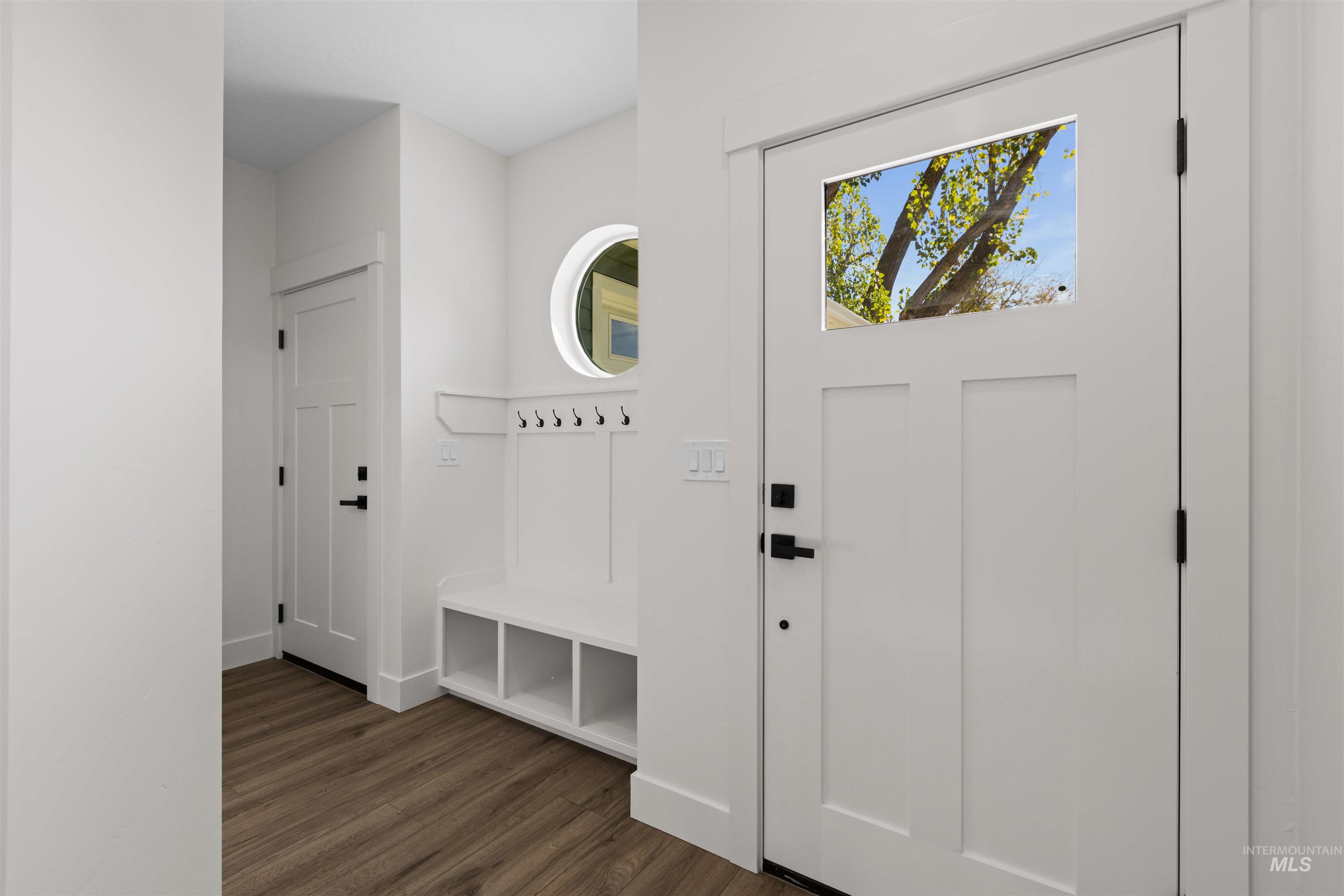 Mudroom featuring dark wood finished floors