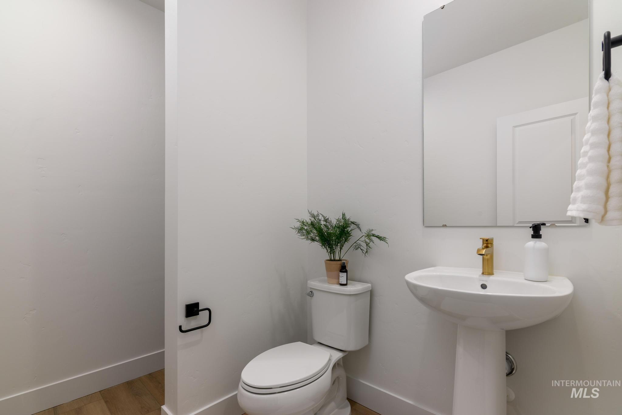 Bathroom with baseboards and wood finished floors